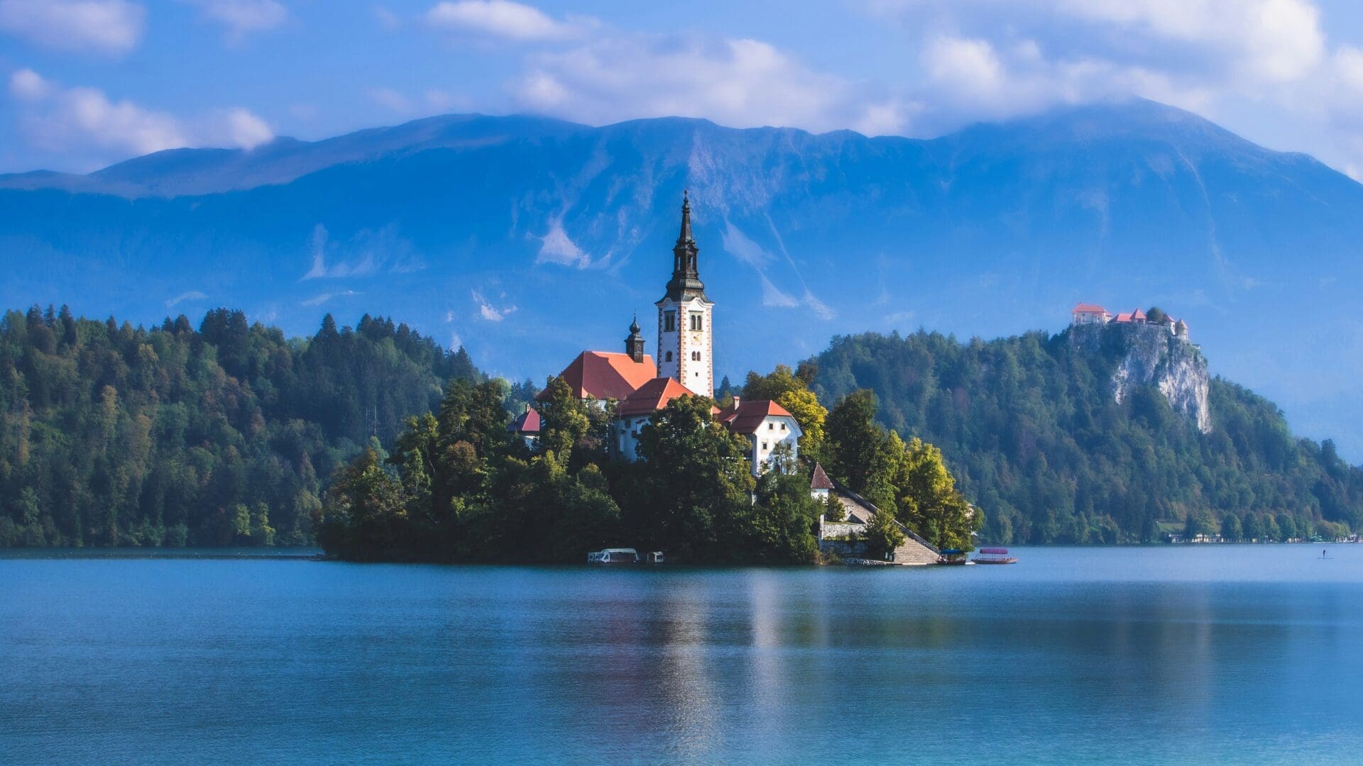 Lake Bled island church and castle reflected on the water, a classic European lake holiday setting in Slovenia