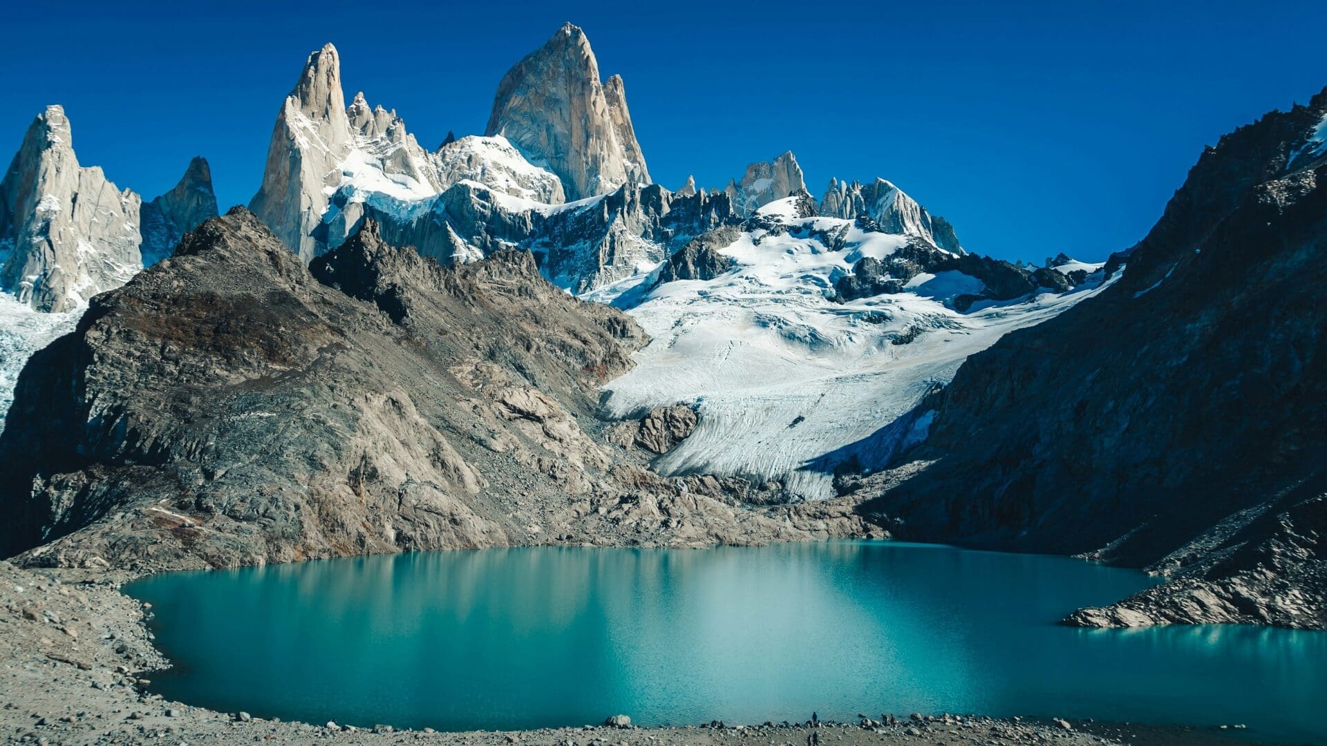Patagonia lake holiday with turquoise glacial water beneath dramatic snow-capped peaks in the Andes